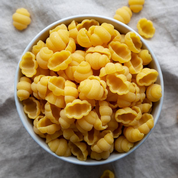istock Dry Organic Gnocchi Pasta in a Bowl, top view. Flat lay, overhead, from above. 1637251921