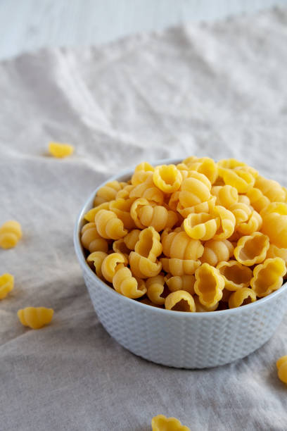 istock Dry Organic Gnocchi Pasta in a Bowl, side view. Space for text. 1637251928