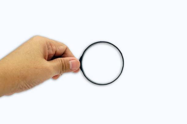 istock Magnifying glass in hand isolated on white background with clipping path, finding concept. 1637253750