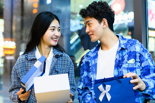 Asian young heterosexual couple sending gift