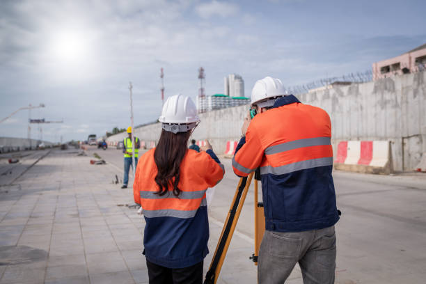 istock Engineer surveyor wearing uniform conversation and check inspection by theodolite camera to measurement level position road construction site is industry transportation concept 1637255009