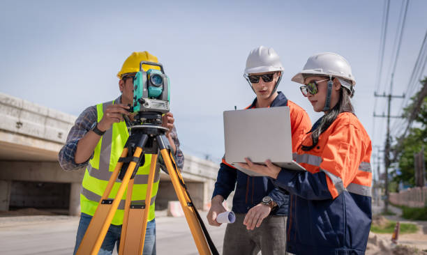 istock Engineer surveyor wearing uniform conversation and check inspection by theodolite camera to measurement level position road construction site is industry transportation concept 1637255096