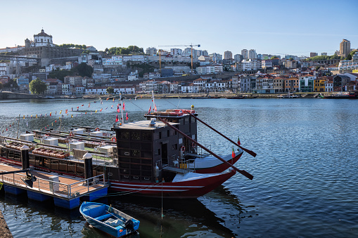 Boats and Douro river in the Ribeira, Porto, Portugal. Vila Nova de Gaia district in the background.