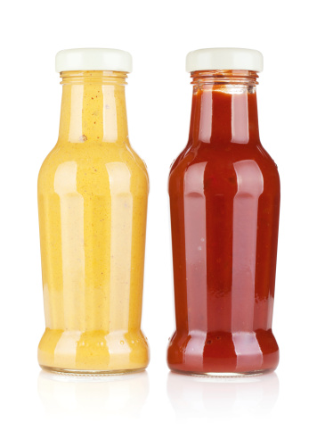 Mustard and ketchup glass bottles. Isolated on white background