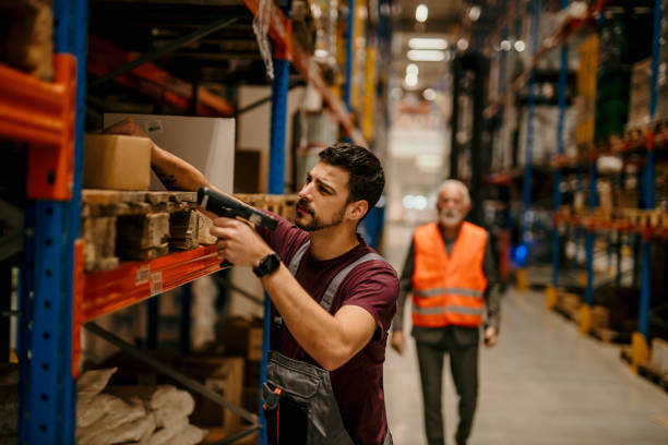 istock Two workers operating barcode printers to generate labels for products, showcasing a behind-the-scenes aspect of inventory management 1637277396