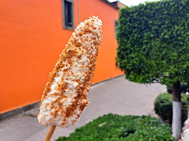 Corn cob and Mexican Elote is grilled corn on the cob slathered in a mayo, chili powder, cheese and lemon are sold from street carts in Mexico