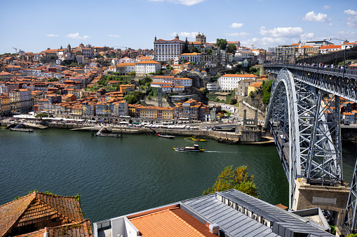 Aerial view cityscape over Douro river, Porto, Portugal. Colorful buildings at the old district of Ribeira and Dom Luis I bridge.