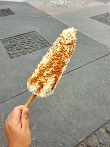 Corn cob and Mexican Elote is grilled corn on the cob slathered in a mayo, chili powder, cheese and lemon are sold from street carts in Mexico