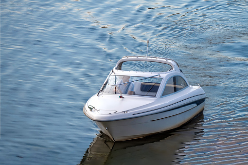 The small motorboat at the pier.