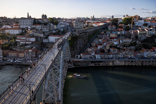 Aerial view cityscape over Douro river at sunset, Porto, Portugal. Colorful buildings at the old district of Ribeira and Dom Luis I Bridge.