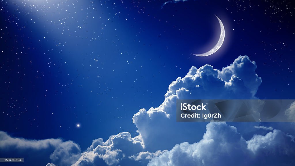 A beautiful night with a blue sky, the moon, and clouds Peaceful background, blue night sky with moon, stars, beautiful clouds and bright spotlight from above. Elements of this image furnished by NASA Cloud - Sky Stock Photo