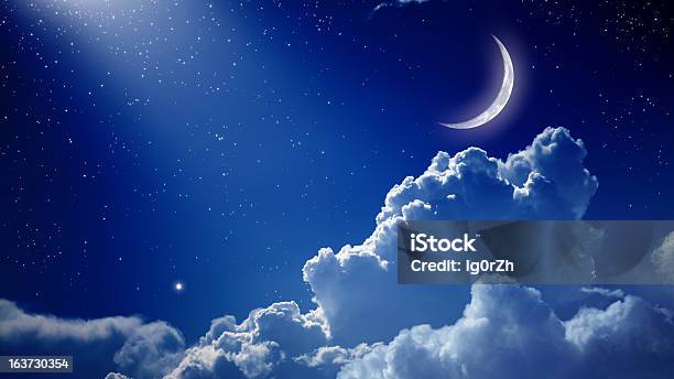 A Beautiful Night With A Blue Sky The Moon And Clouds Stock Photo - Download Image Now