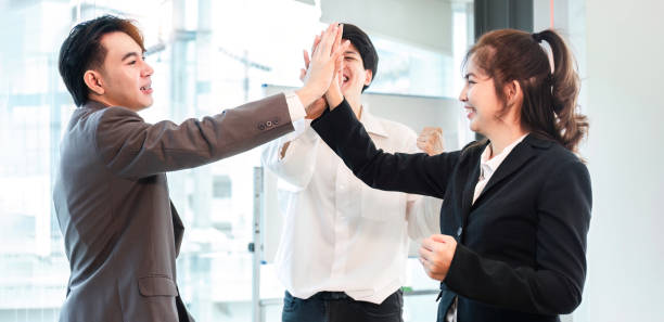 istock Successful business people celebrating teamwork in the office. 1637303656