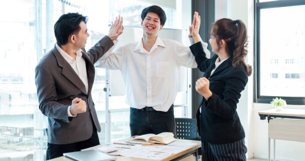 istock Successful business people celebrating teamwork in the office. 1637304169