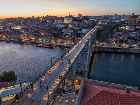 Aerial view cityscape over Douro river at twilight, Porto, Portugal. Colorful buildings at the old district of Ribeira and Dom Luis I Bridge.