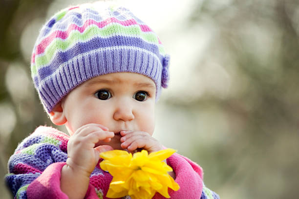 istock Baby-girl and yellow daffodil 163733474