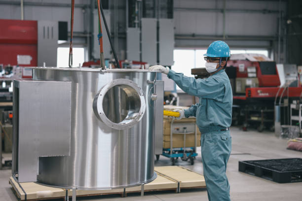 Mature Male engineer working at factory.  They manufacture products and process metals or making car parts etc...