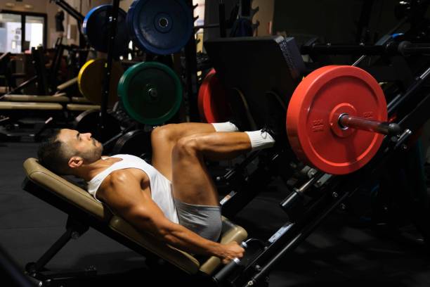 istock Strong Latin man doing leg press at a gym. 1637362898