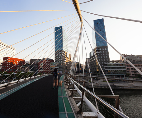 Bilbao, Spain - August 02, 2022: The Zubizuri arch footbridge in Bilbao designed by the Architect Santiago Calatrava