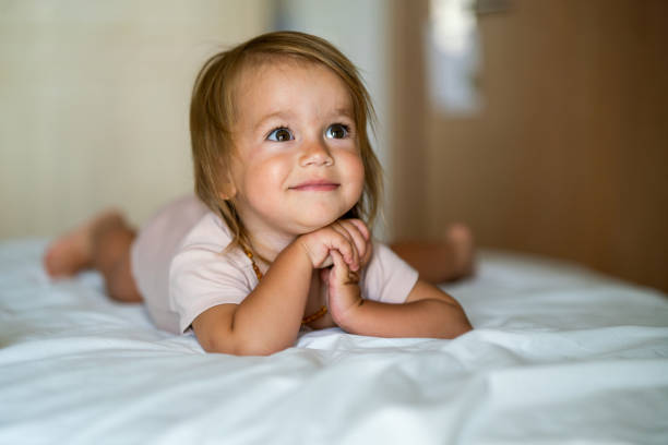 istock Small girl lying on the bed 1637379506
