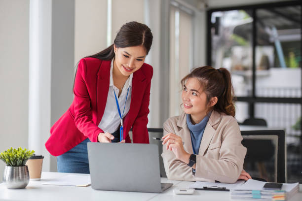 istock Two business women are discussing and exchanging knowledge on graphs and finance data. 1637385982