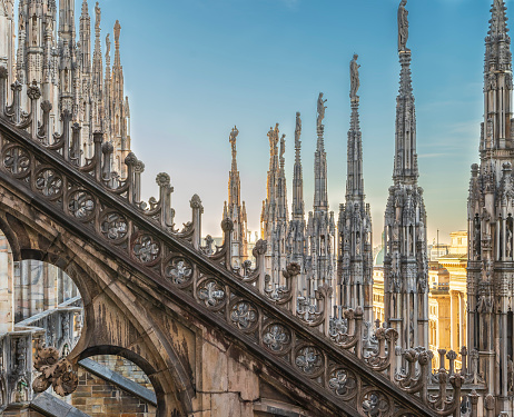 Decorated flying buttress and rows of pinnacle sculptures on the rooftop aisle of Milan Cathedral