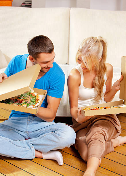 istock romantic couple eating pizza at home 163741395