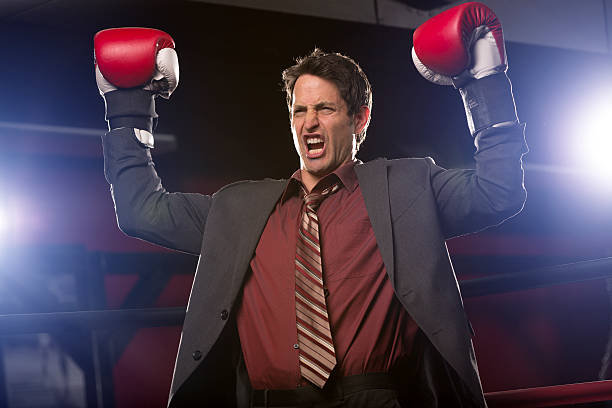 istock Businessman in boxing ring victorious after battle 163742106