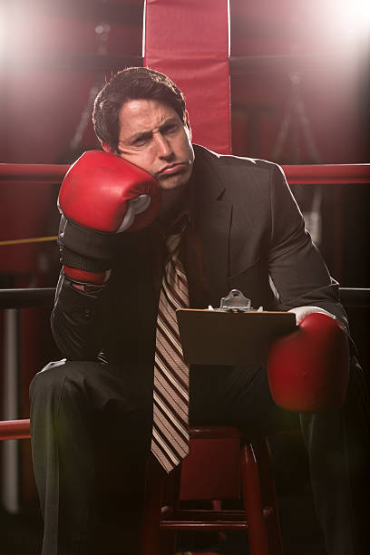 istock Businessman beat against the ropes with ice pack on head 163742109