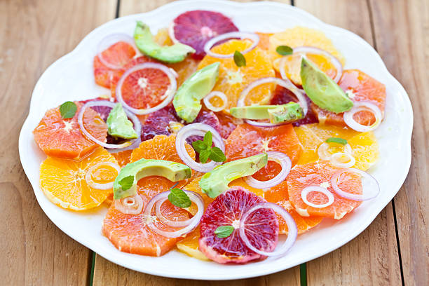 Salat mit Zitrusfrüchten, Avocado und Zwiebel. – Foto