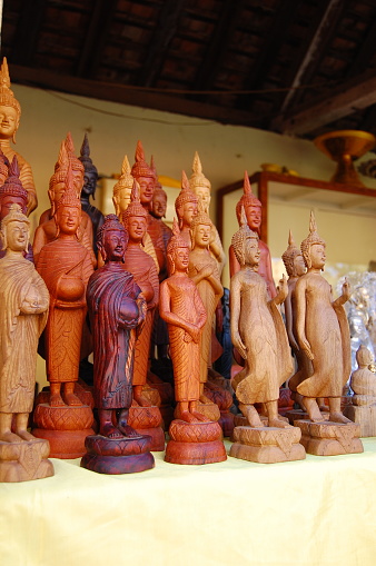 Wooden statue for sale in a shop of Vientiane city, Laos.