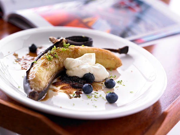 Banana dessert peel blueberries whipped cream white Plate stock photo