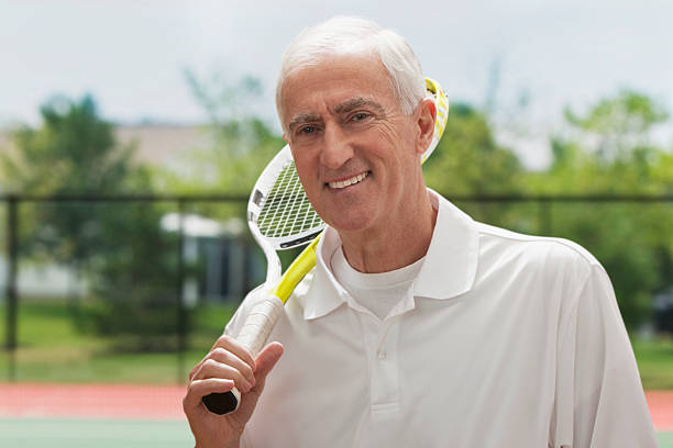 istock Senior man holding tennis racquet 163746171