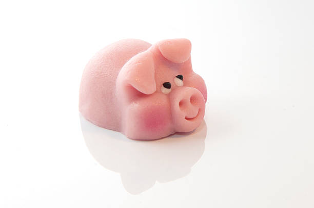 pink marzipan pig pink marzipan pig on the white background marzipan stock pictures, royalty-free photos & images