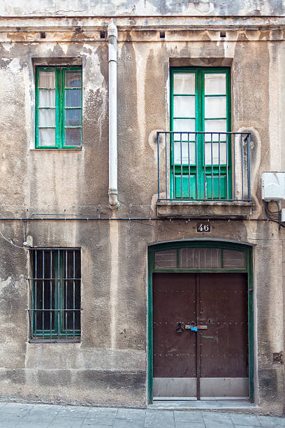 Facade with metal door, windows and balcony stock photo
