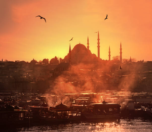 Fantastic view of Ortakoy Buyuk Mecidiye Camii, Bosphorus and 15 Temmuz Sehitler Koprusu against beautiful vanilla sky background on a snowy winter day in Istanbul, Turkey