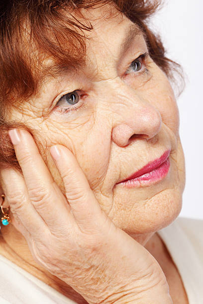 istock Senior woman leaned head on hand, close 163748333