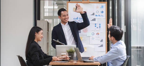 istock colleagues asking a question to a businessman during a presentation. 1637494065