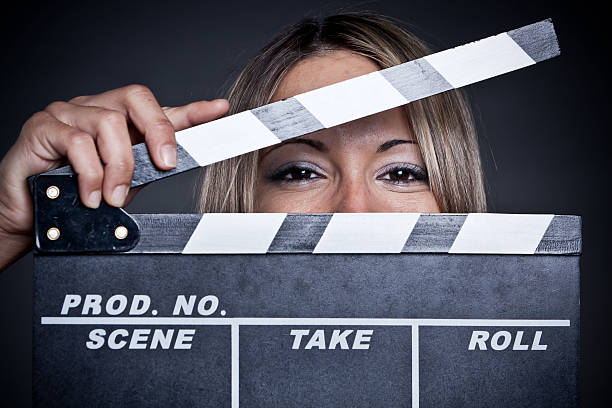 istock Pretty young woman holding a clapper. 163749410