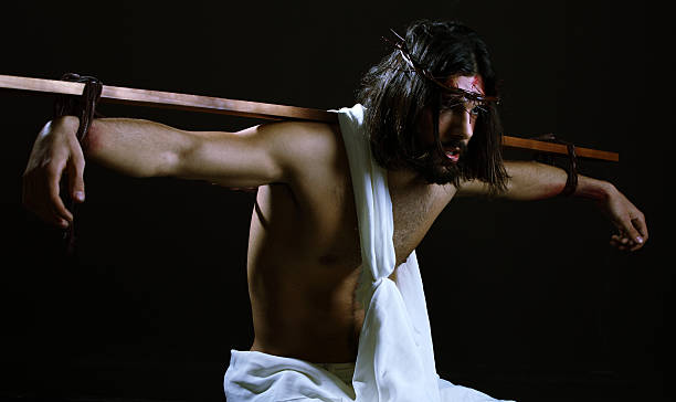 istock Jesus Christ with Cross strapped to his back 163751812