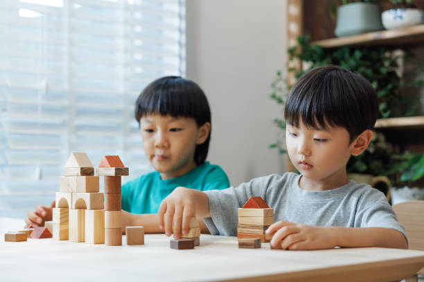 istock Little boys playing with toy blocks 1637523856
