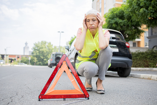 Woman has a car malfunction