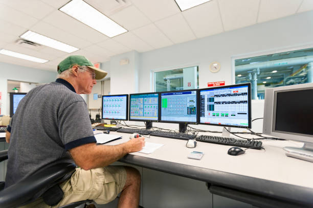 Control Room Technician monitoring water wells at a public water utility plant. public utility stock pictures, royalty-free photos & images