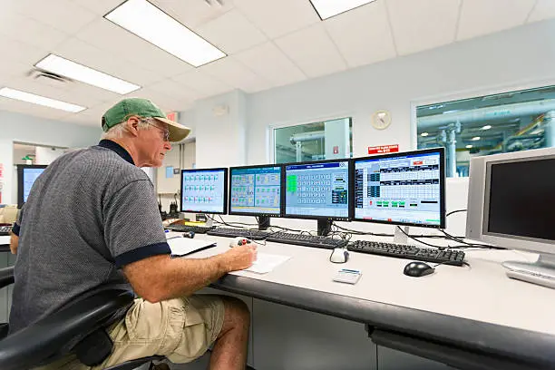 Technician monitoring water wells at a public water utility plant.