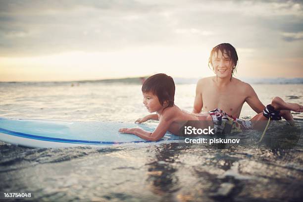 Surfing Study Stock Photo - Download Image Now - Boys, Breaking Wave, Surfing