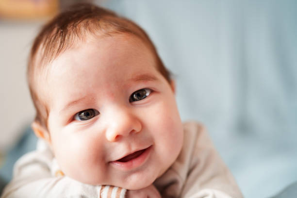 istock Portrait of a smiling baby lying on front 1637540597