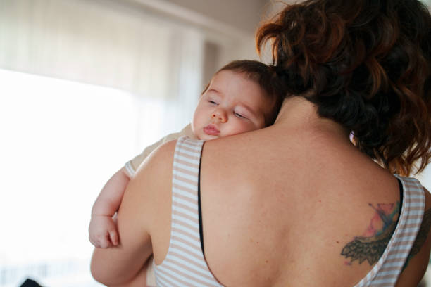 istock Newborn baby on mother shoulder. 1637543461