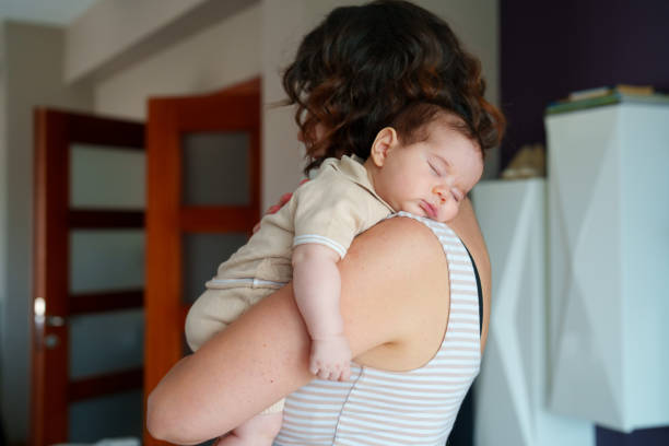 istock New baby sleep on his mother shoulder 1637552612