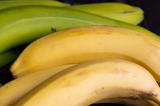 Ripe yellow bananas on the table, a bunch of ripe delicious bananas on a blackboard