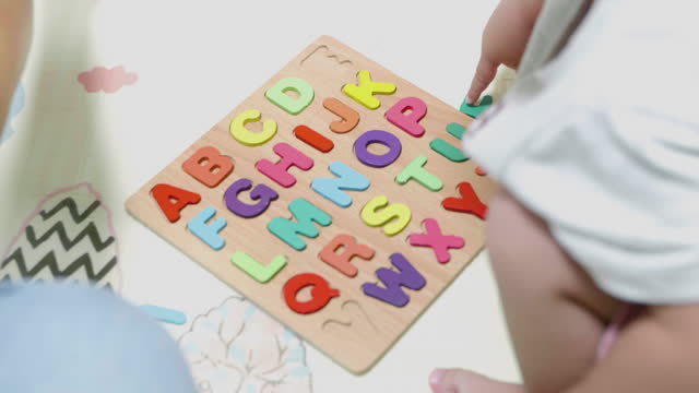 Close up - Asian boy play with English letters. Learn to use language.